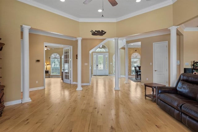 living room featuring decorative columns, ceiling fan, and light hardwood / wood-style floors