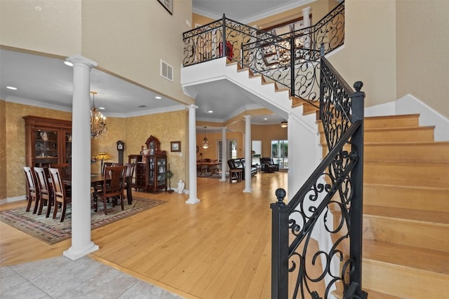 foyer with wood-type flooring and decorative columns