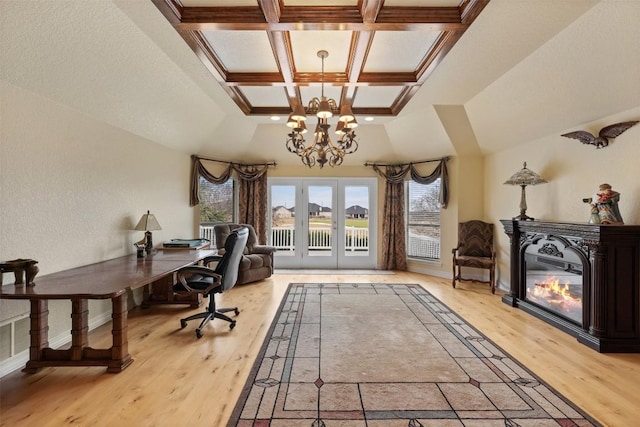 home office featuring coffered ceiling, french doors, a chandelier, and light wood-type flooring