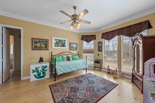 bedroom with ceiling fan, ornamental molding, and light hardwood / wood-style floors