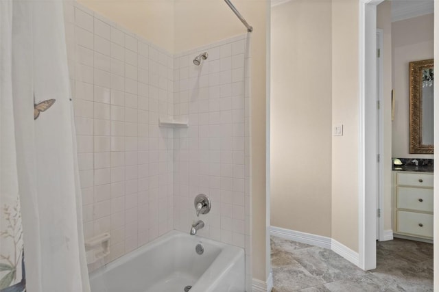 bathroom featuring tiled shower / bath combo and vanity