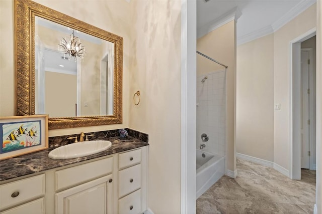 bathroom featuring crown molding, tiled shower / bath, vanity, and a chandelier