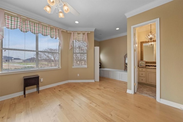 unfurnished room with crown molding, ceiling fan with notable chandelier, and light hardwood / wood-style floors