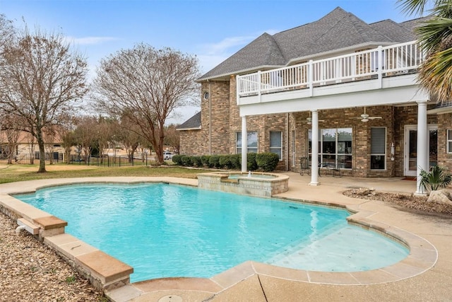 view of pool featuring a patio, ceiling fan, and an in ground hot tub