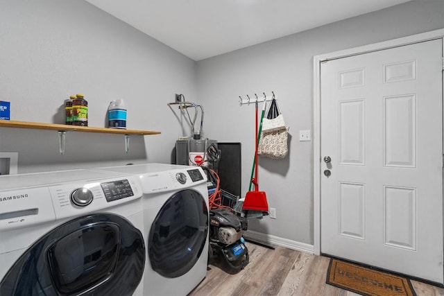 laundry room featuring washer and clothes dryer and light hardwood / wood-style floors