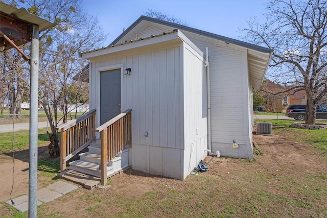 view of side of home with central AC