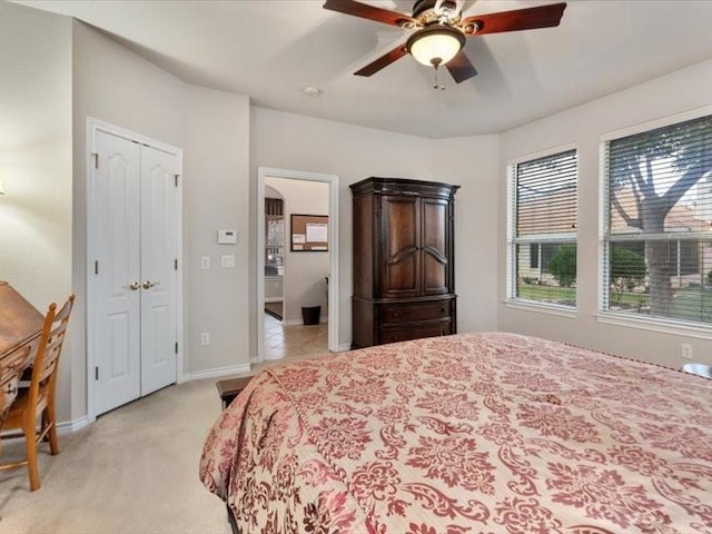 bedroom featuring light carpet and ceiling fan