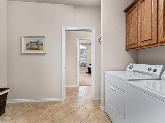 laundry area with cabinets, light tile patterned floors, and independent washer and dryer