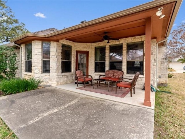 view of patio / terrace with ceiling fan and an outdoor living space