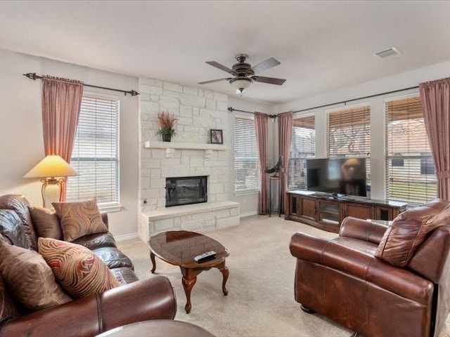 909 Big Thicket St, Georgetown, TX 78633 - living room with ceiling fan, light colored carpet, plenty of natural light, and a fireplace