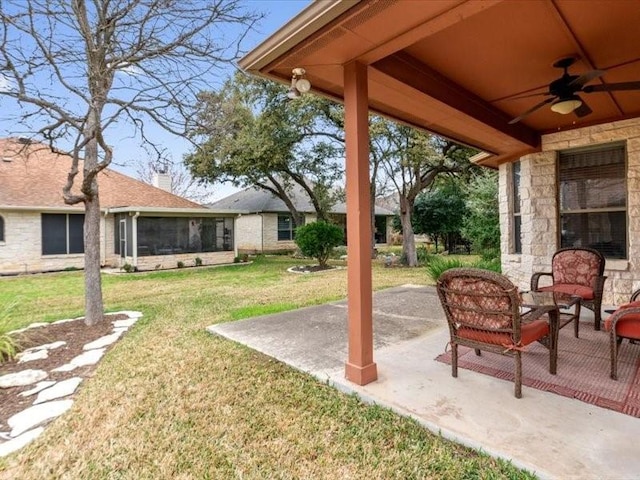 view of yard with a sunroom, a patio, and ceiling fan