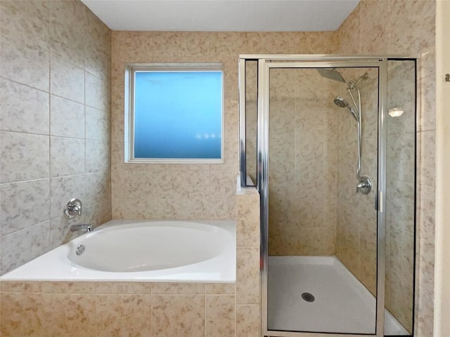 bathroom featuring separate shower and tub