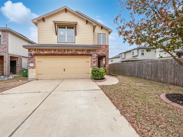 view of property featuring a garage and a front yard