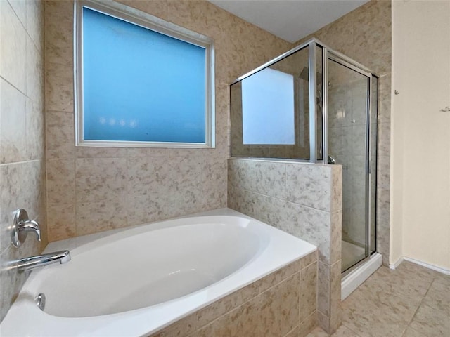 bathroom with tile patterned flooring and shower with separate bathtub