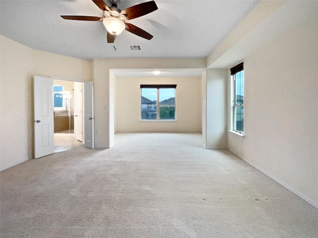 spare room featuring ceiling fan and light carpet