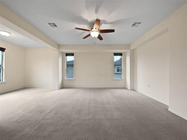 spare room featuring carpet and ceiling fan