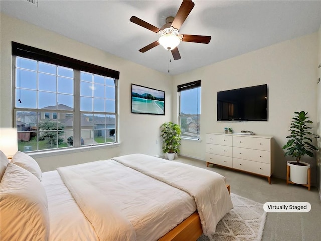 bedroom with light carpet and ceiling fan