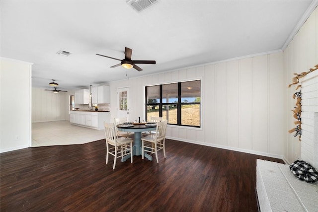 dining space with ceiling fan and wood-type flooring