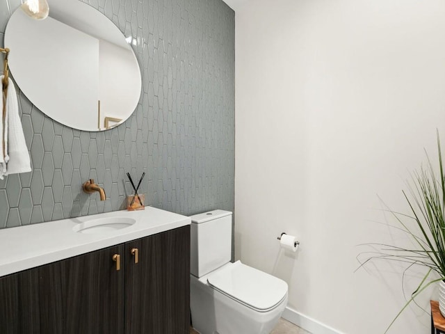 bathroom featuring vanity, toilet, and tile walls