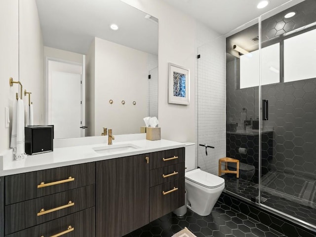 bathroom with vanity, tile patterned flooring, a shower with shower door, and toilet