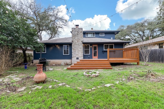 back of house featuring a yard and a deck