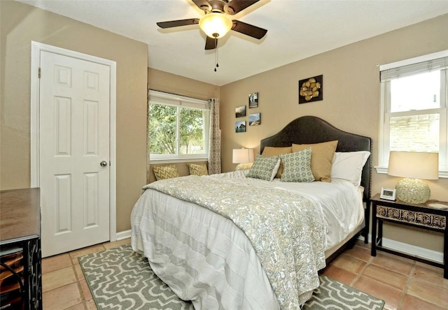 tiled bedroom with ceiling fan