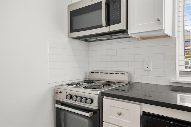 kitchen featuring white cabinetry, electric range oven, and backsplash