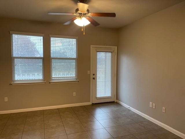 tiled empty room with ceiling fan