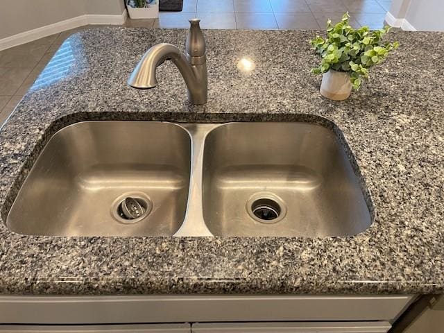 room details with sink and dark stone countertops