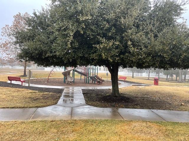 surrounding community with a yard and a playground