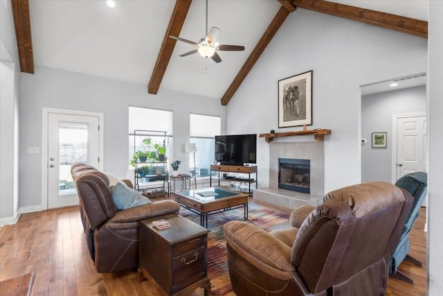 1430 Antioch Rd, Paige, TX 78659 - living room with a ceiling fan, beamed ceiling, hardwood / wood-style flooring, a fireplace, and high vaulted ceiling