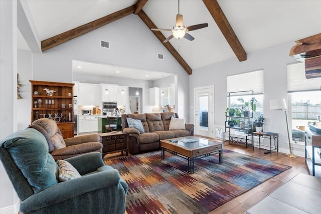 1430 Antioch Rd, Paige, TX 78659 - living room with high vaulted ceiling, beamed ceiling, dark wood-style floors, and ceiling fan