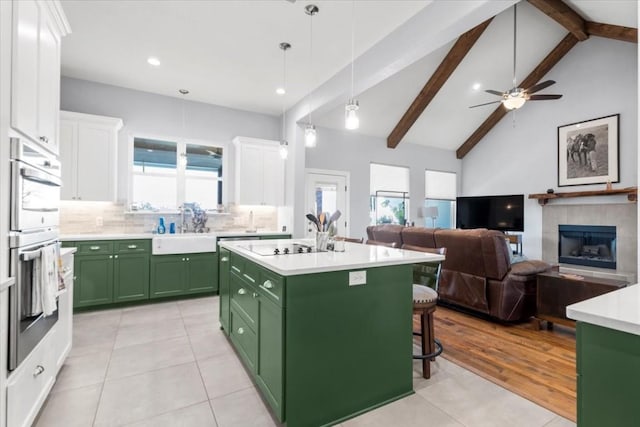 1430 Antioch Rd, Paige, TX 78659 - kitchen featuring green cabinets, white cabinetry, light tile patterned floors, light countertops, and tasteful backsplash