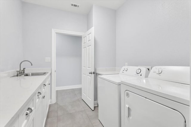 1430 Antioch Rd, Paige, TX 78659 - washroom featuring washing machine and dryer, light tile patterned floors, and cabinet space