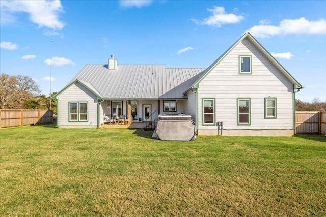 1430 Antioch Rd, Paige, TX 78659 - back of property with a fenced backyard, a chimney, and a metal roof