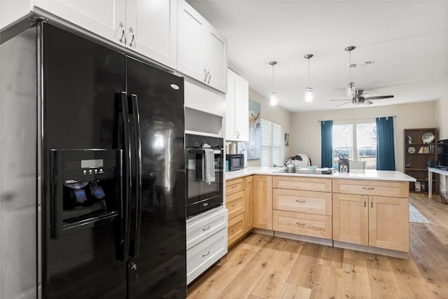 1430 Antioch Rd, Paige, TX 78659 - kitchen featuring black appliances, light brown cabinetry, a peninsula, ceiling fan, and light wood-type flooring