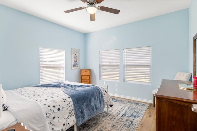 1430 Antioch Rd, Paige, TX 78659 - bedroom with multiple windows, light wood-style flooring, and ceiling fan