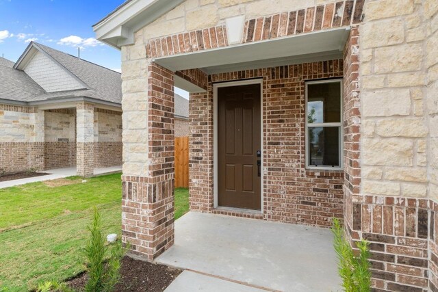 4829 Mozzafiato Ln, Round Rock, TX 78665 - entrance to property featuring brick siding, a shingled roof, and stone siding
