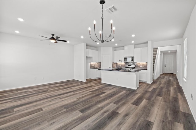 kitchen with dark countertops, decorative backsplash, appliances with stainless steel finishes, visible vents, and recessed lighting