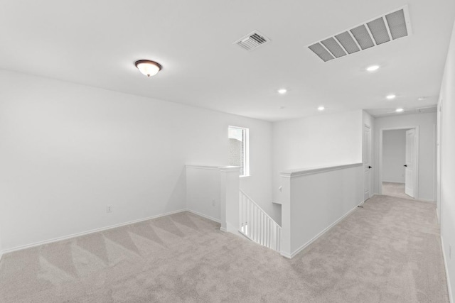 empty room with recessed lighting, carpet, visible vents, and baseboards