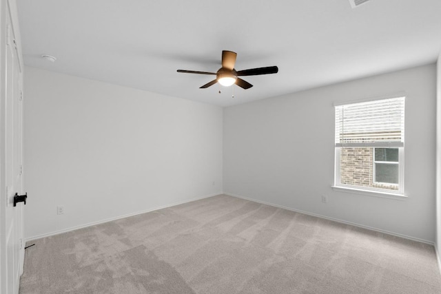 spare room with baseboards, a ceiling fan, and carpet flooring