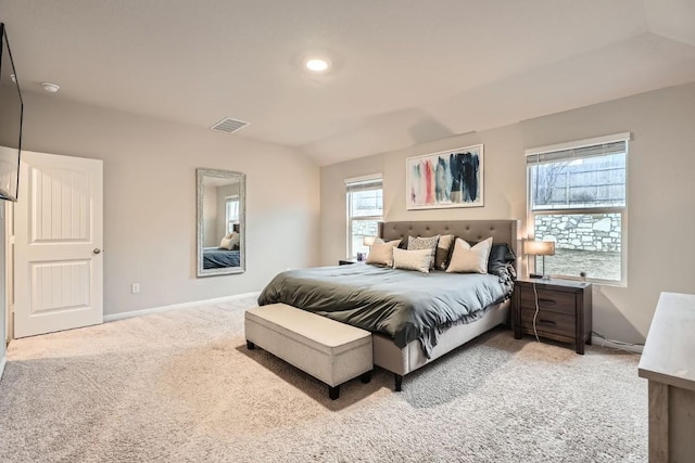 bedroom with light carpet and lofted ceiling