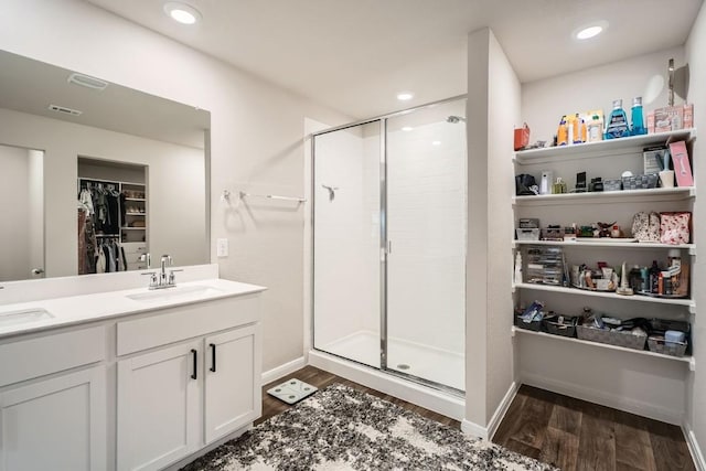 bathroom with vanity, hardwood / wood-style floors, and an enclosed shower