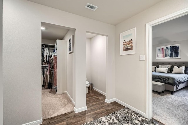 hallway with dark hardwood / wood-style floors