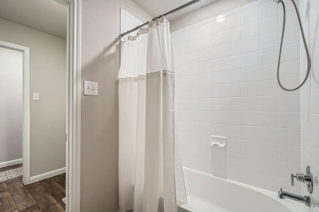 bathroom featuring hardwood / wood-style floors and shower / bath combo