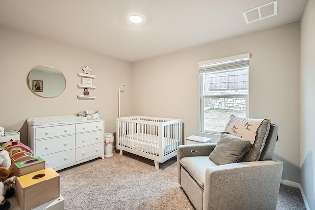 carpeted bedroom featuring a crib