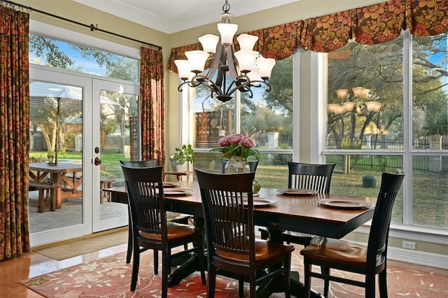 dining space featuring ornamental molding, a notable chandelier, and french doors