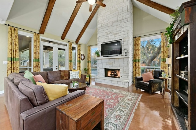 living room with ceiling fan, high vaulted ceiling, a stone fireplace, french doors, and beamed ceiling