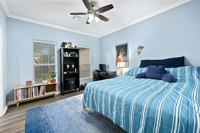 bedroom featuring ceiling fan, ornamental molding, and dark hardwood / wood-style flooring