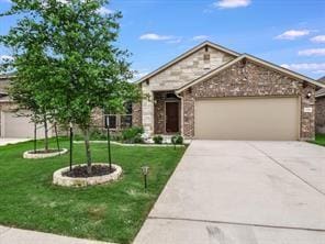 craftsman-style home featuring a garage and a front yard